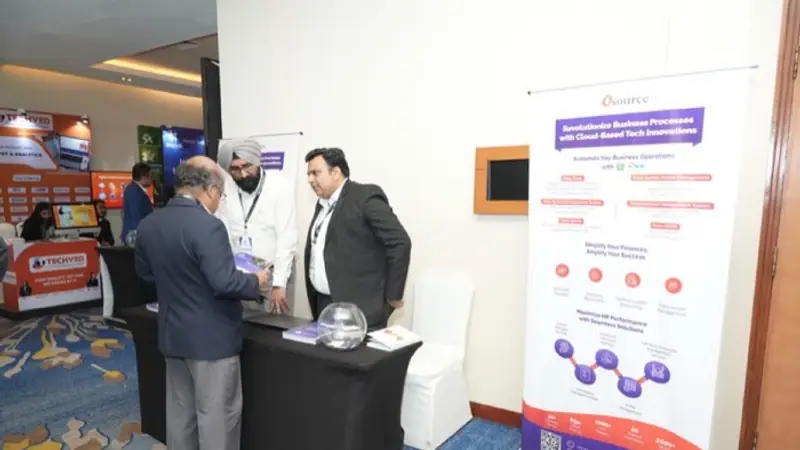 Exhibition stand on the floor of an Empiric Business Media event, with delegates in conversation