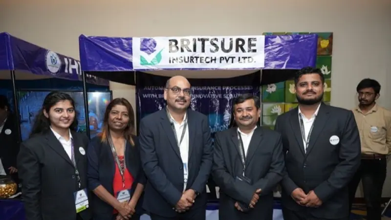 Exhibition stand on the floor of an Empiric Business Media event, with delegates in conversation