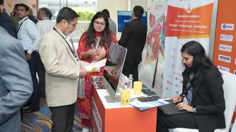 Exhibition stand on the floor of an Empiric Business Media event, with delegates in conversation
