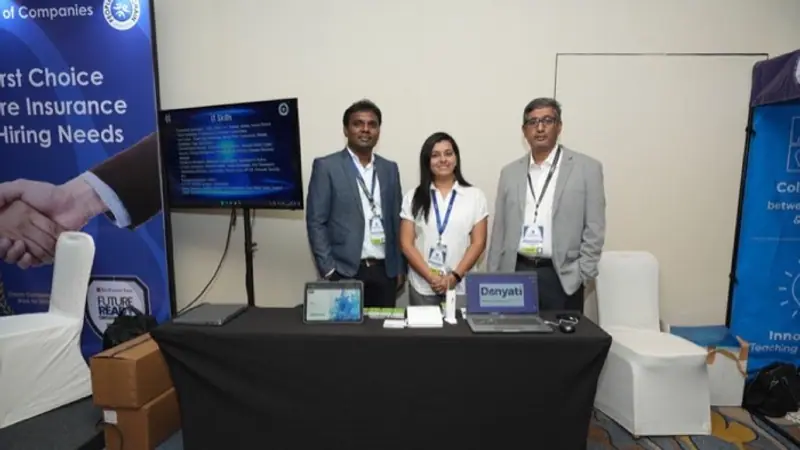 Exhibition stand on the floor of an Empiric Business Media event, with delegates in conversation