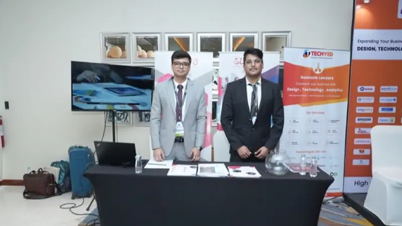 Exhibition stand on the floor of an Empiric Business Media event, with delegates in conversation