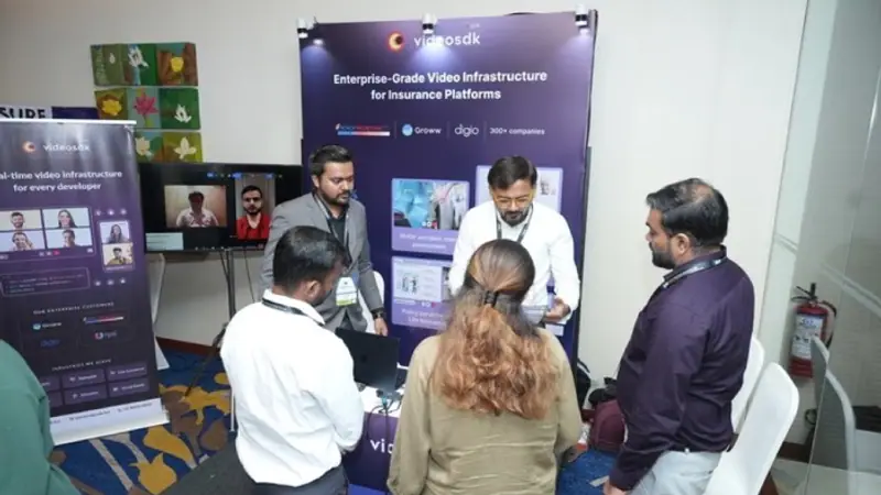 Exhibition stand on the floor of an Empiric Business Media event, with delegates in conversation