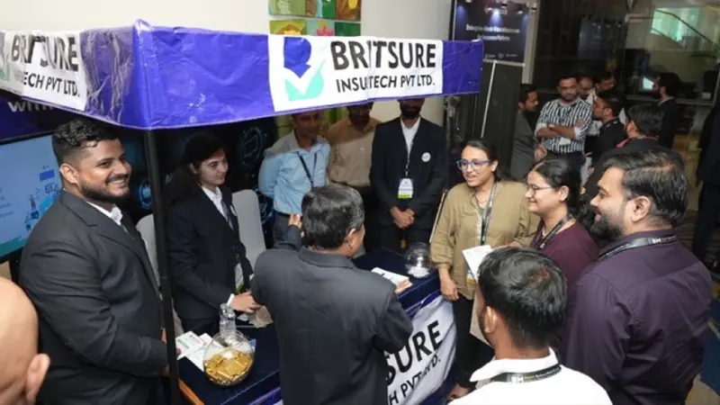 Exhibition stand on the floor of an Empiric Business Media event, with delegates in conversation
