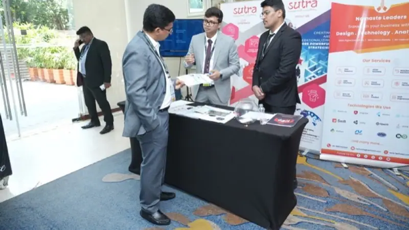 Exhibition stand on the floor of an Empiric Business Media event, with delegates in conversation
